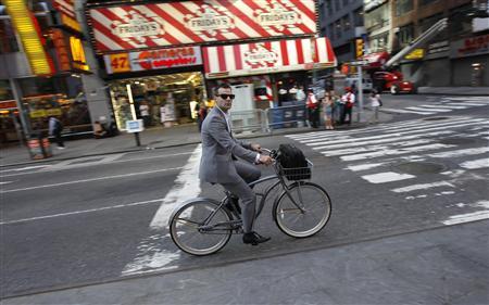 File photo of a man riding a bicycle down 7th Avenue through Times Square in the early morning